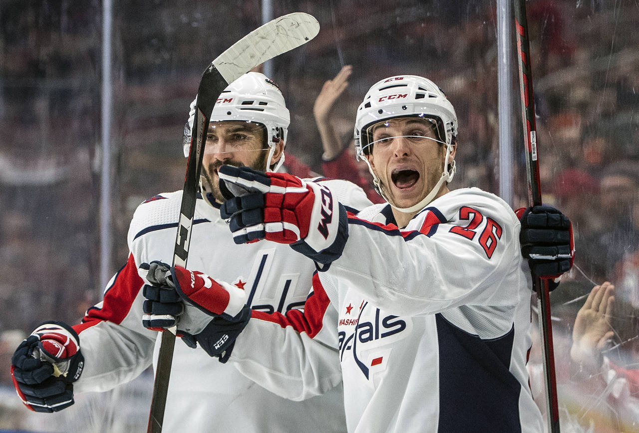 Washington Capitals' Nic Dowd (26) and Trevor van Riemsdyk (57) celebrate a goal against the Edmont...