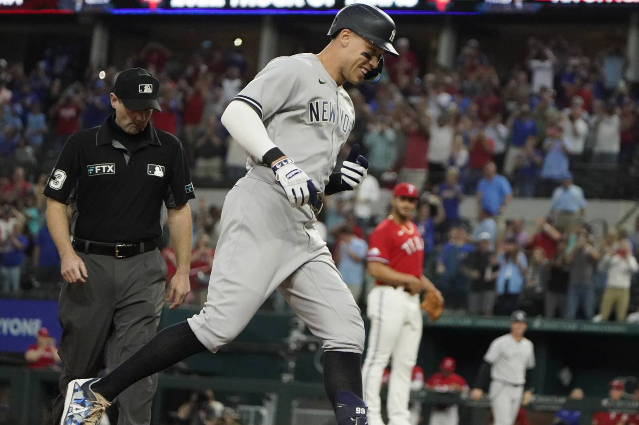 FILE - New York Yankees' Aaron Judge runs out his solo home run, his 62nd of the season, as Texas R...
