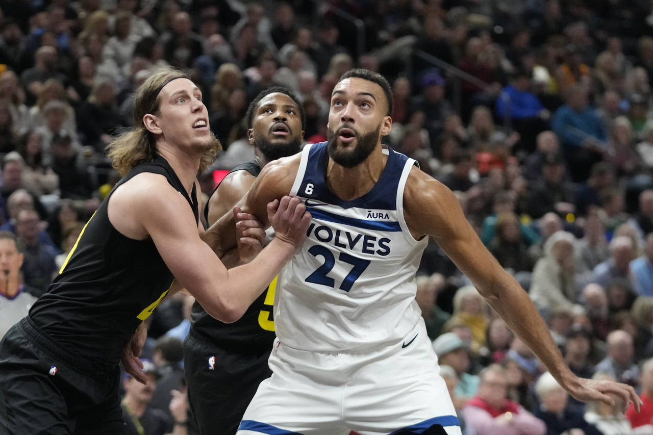 Utah Jazz forward Kelly Olynyk, left, and Minnesota Timberwolves center Rudy Gobert (27) look for a...