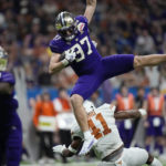 
              Washington tight end Jack Westover (37) is upended by Texas linebacker Jaylan Ford (41) after making a catch during the second half of the Alamo Bowl NCAA college football game in San Antonio, Thursday, Dec. 29, 2022. (AP Photo/Eric Gay)
            