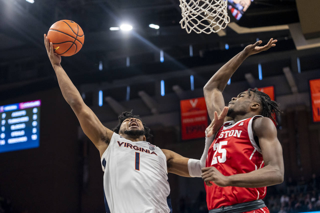 Virginia forward Jayden Gardner (1) throws the ball up against. Houston forward Jarace Walker (25) ...