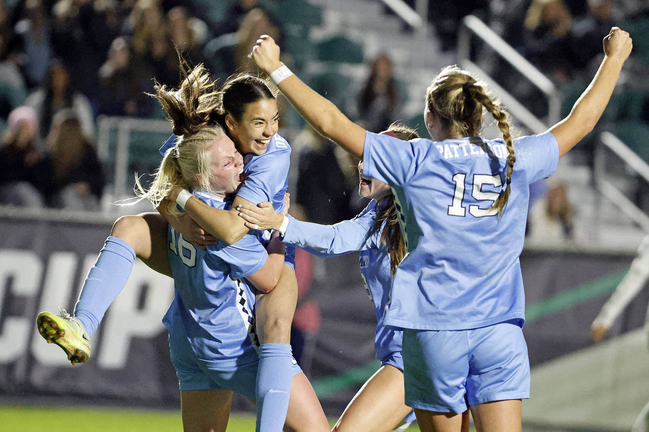 North Carolina's Aleigh Gambone (16) is congratulated on her goal against Florida State by Tori Del...