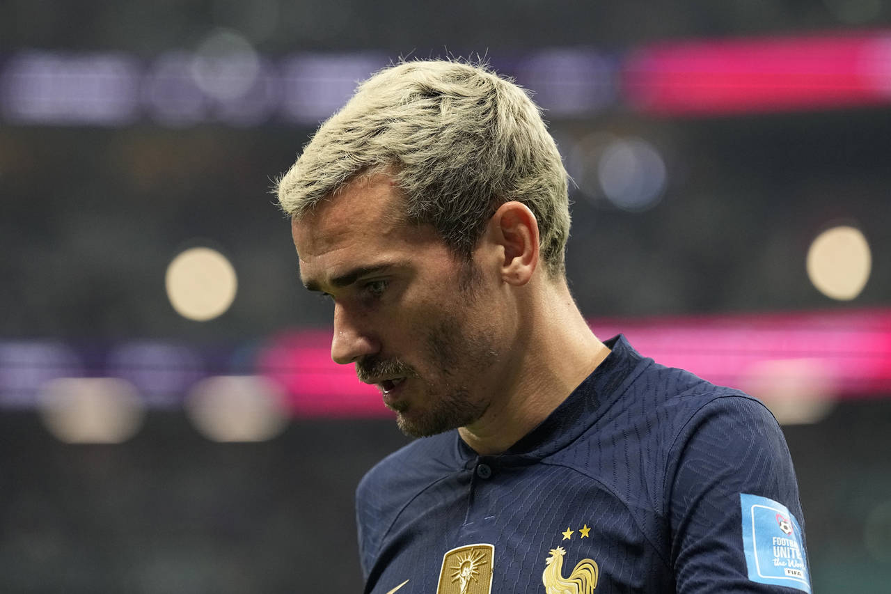 France's Antoine Griezmann walks to take a corner kick during the World Cup quarterfinal soccer mat...