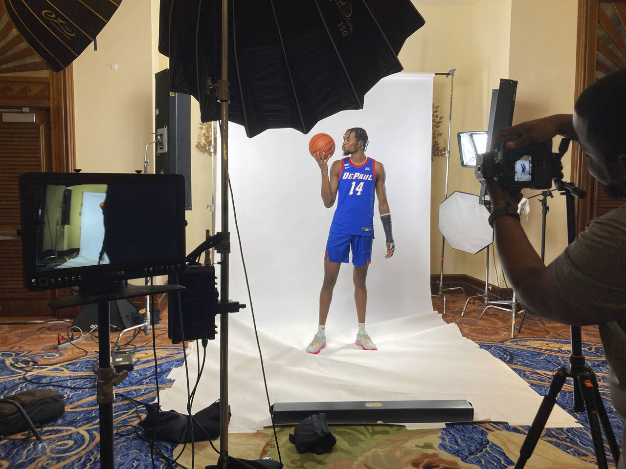 DePaul's Nick Ongenda, of Canada, poses for photos in Paradise Island, Bahamas, Nov. 19, 2022. Coll...