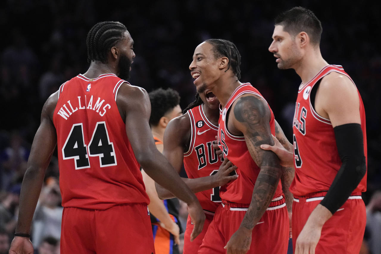 Chicago Bulls' DeMar DeRozan, front center, reacts after hitting the winning basket during the seco...
