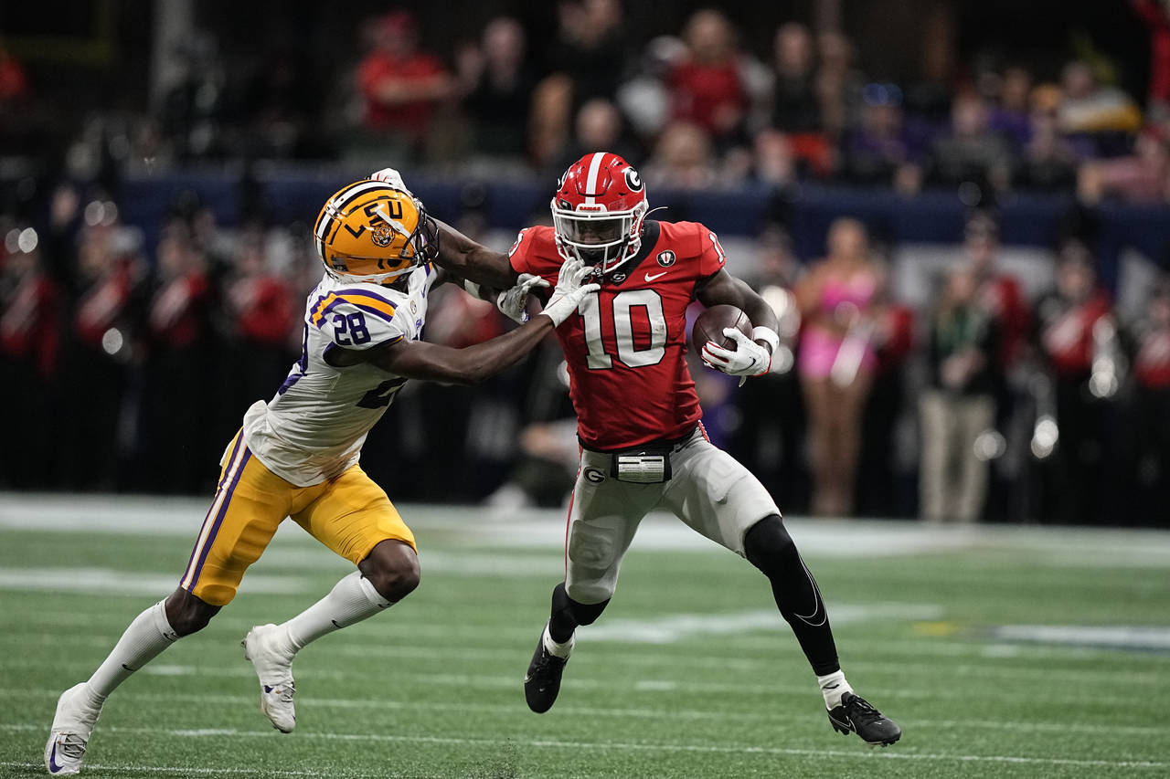 Georgia wide receiver Kearis Jackson (10) stiff arms LSU safety Major Burns (28) first half of the ...