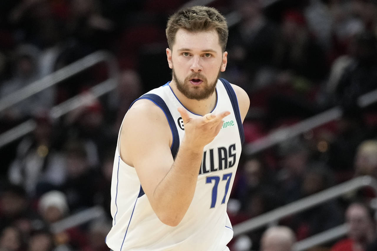 Dallas Mavericks guard Luka Doncic reacts after making a 3-point basket during the second half of a...