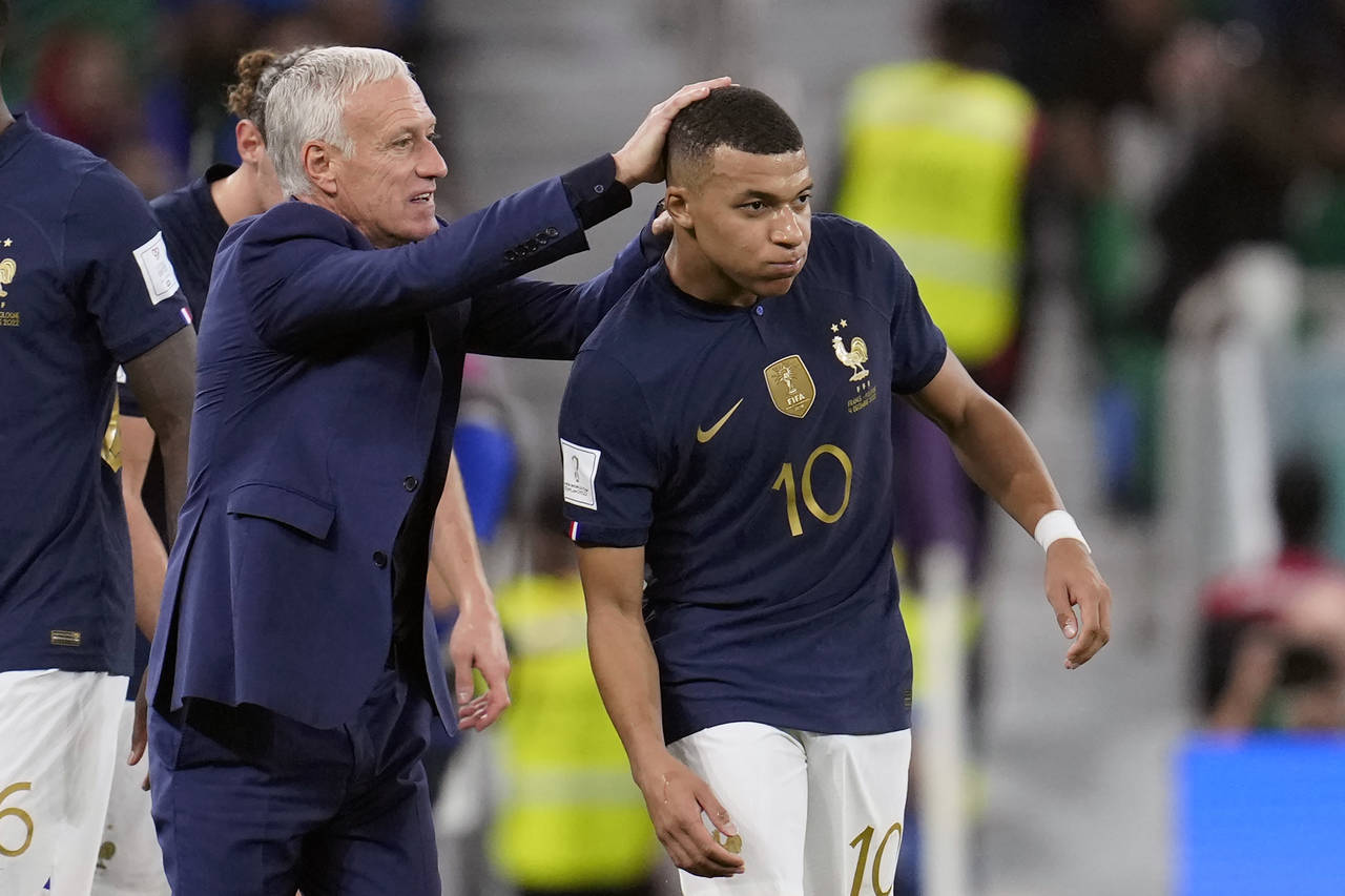 France's head coach Didier Deschamps, left, celebrates a goal by France's Kylian Mbappe, right, dur...