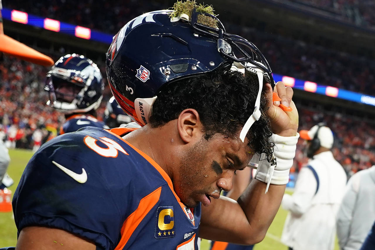 Denver Broncos quarterback Russell Wilson (3) removes his helmet after a concussion against the Kan...