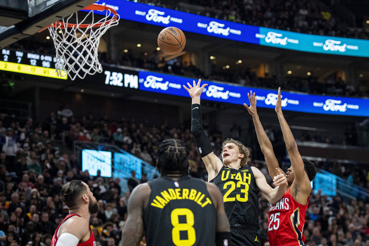Utah Jazz forward Lauri Markkanen (23) lays the ball up while contested by New Orleans Pelicans gua...