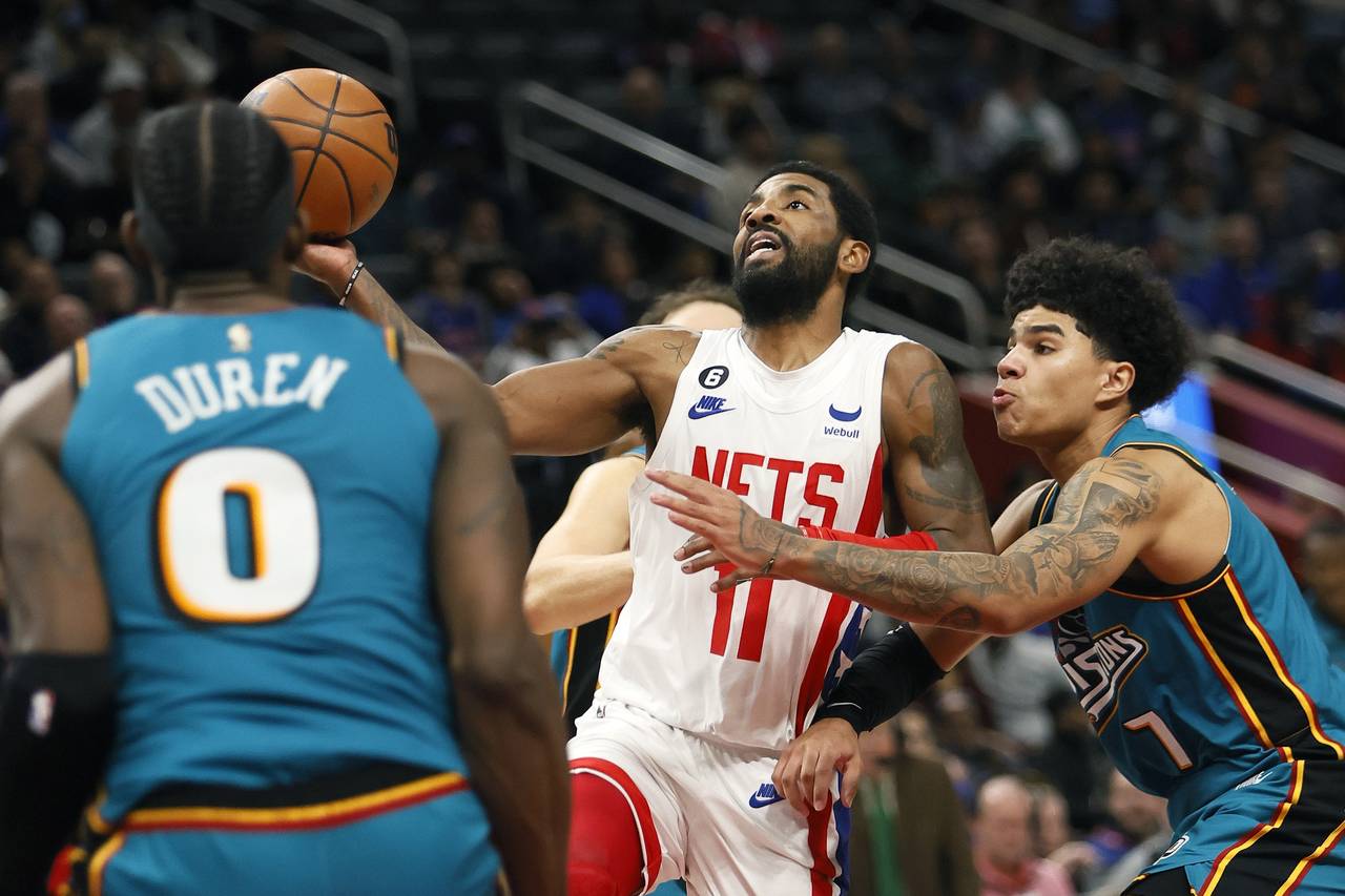 Brooklyn Nets guard Kyrie Irving (11) goes to the basket against Detroit Pistons center Jalen Duren...