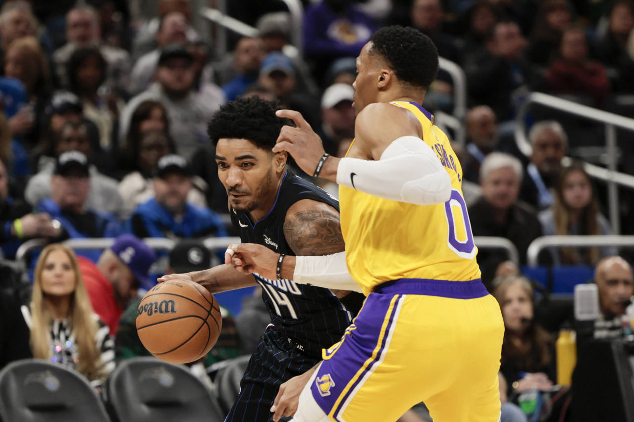 Orlando Magic guard Gary Harris (14) drives against Los Angeles Lakers guard Russell Westbrook (0) ...