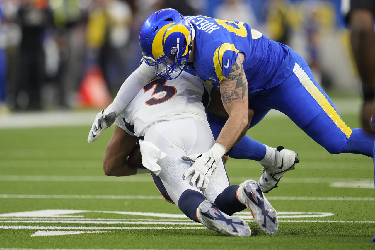 Los Angeles Rams defensive tackle Michael Hoecht sacks Denver Broncos quarterback Russell Wilson du...