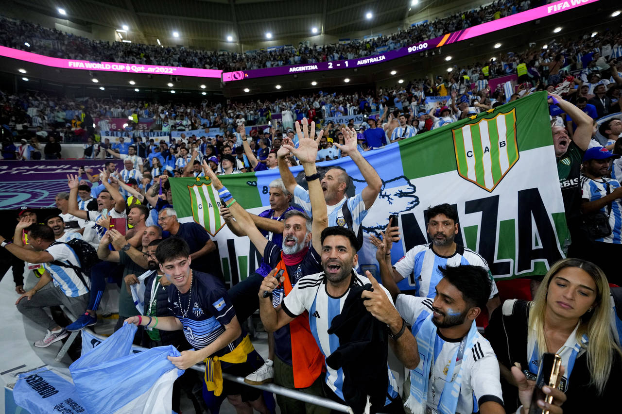Argentina's fans celebrate winning the World Cup round of 16 soccer match between Argentina and Aus...