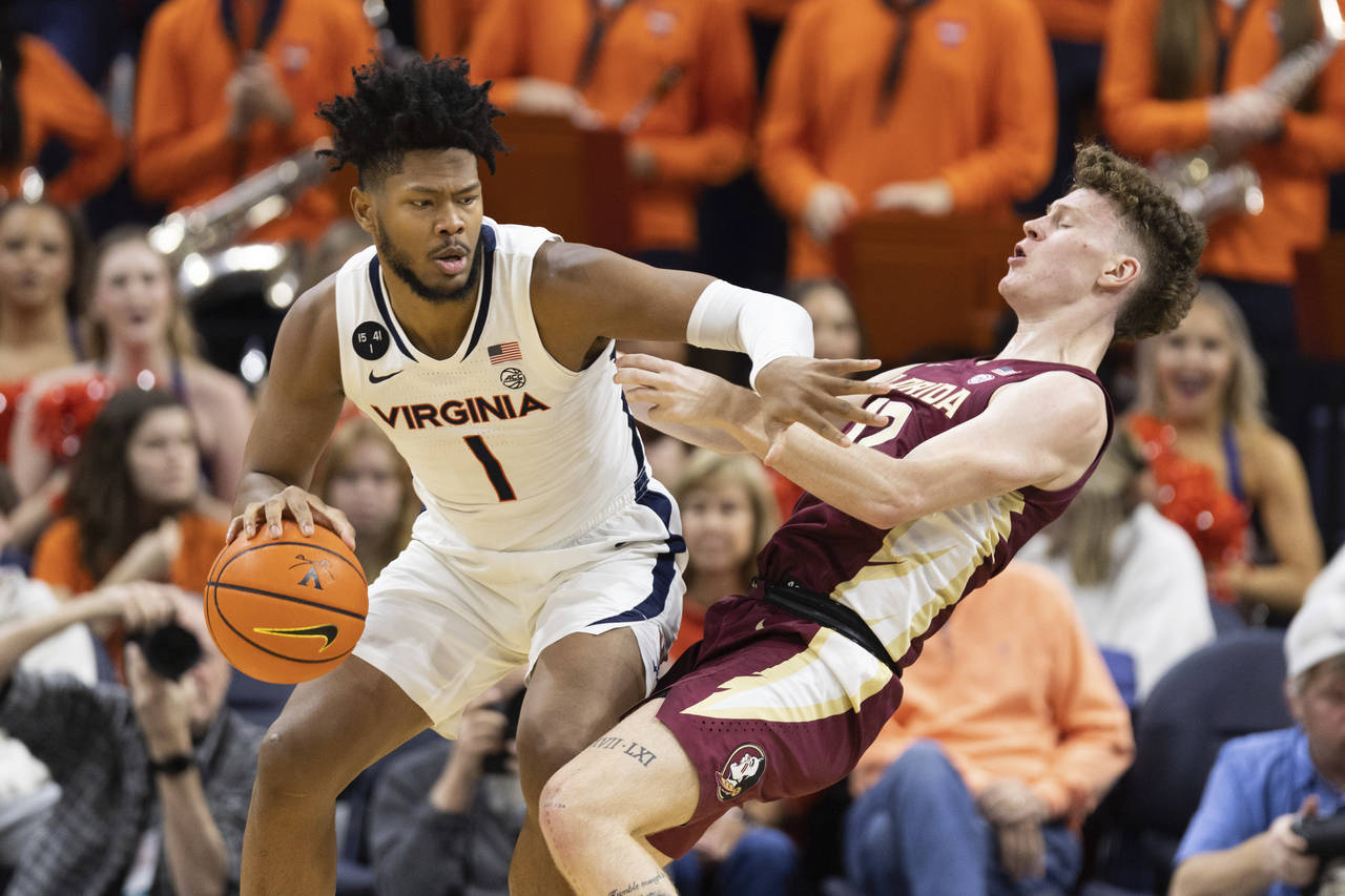 Virginia's Jayden Gardner (1) commits a foul against Florida during the first half of an NCAA colle...