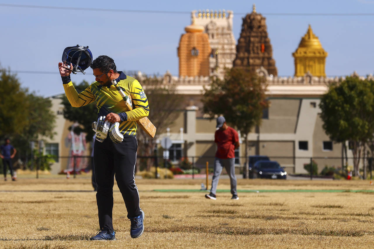 Pavan Kumar Machiraju walks off the field after batting during a cricket match between the Dallas C...