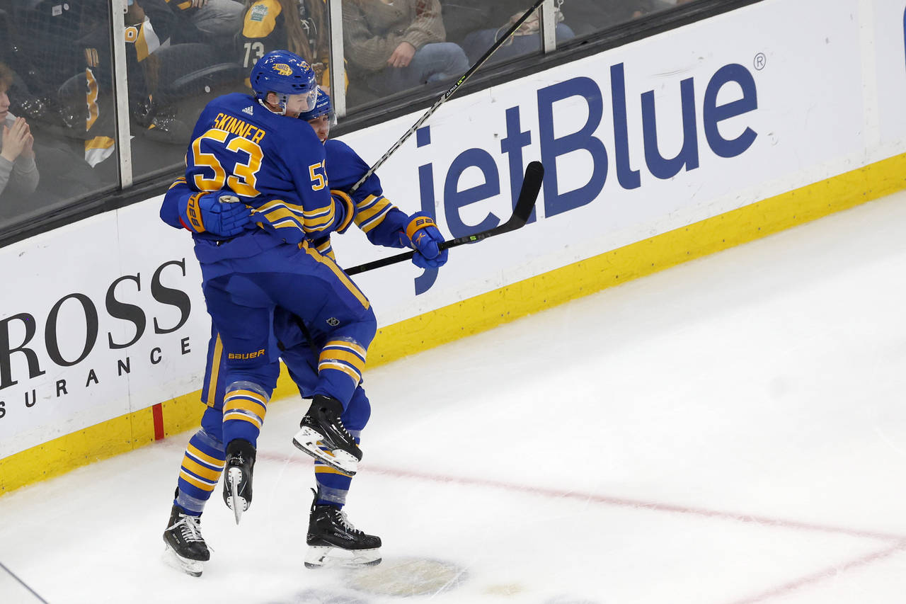 Buffalo Sabres left wing Jeff Skinner (53) leaps into Dylan Cozens arms after Cozens score the game...