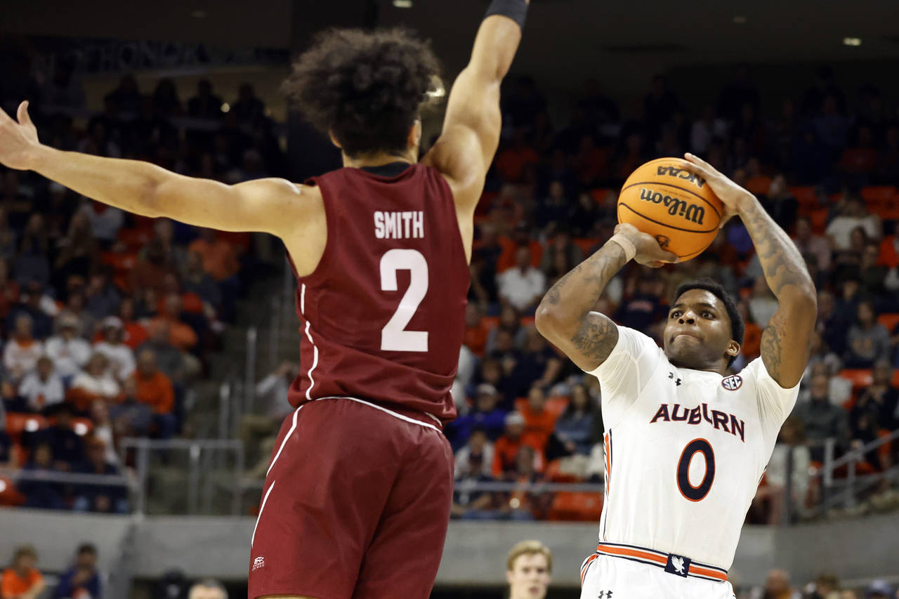 Auburn guard K.D. Johnson (0) shoots as Colgate guard Braeden Smith (2) defends during the second h...