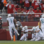 
              Miami Dolphins players celebrate after a touchdown pass from quarterback Tua Tagovailoa (1) to wide receiver Trent Sherfield, left, during the first half of an NFL football game against the San Francisco 49ers in Santa Clara, Calif., Sunday, Dec. 4, 2022. (AP Photo/Jed Jacobsohn)
            