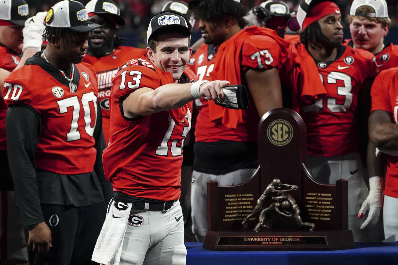 Georgia quarterback Stetson Bennett (13) gestures to the crowd during the trophy presentation the S...