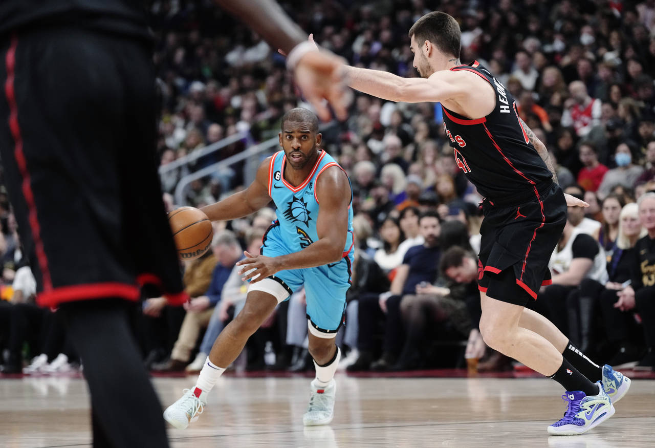 Phoenix Suns guard Chris Paul (3) looks for a way past Toronto Raptors forward Juancho Hernangomez ...