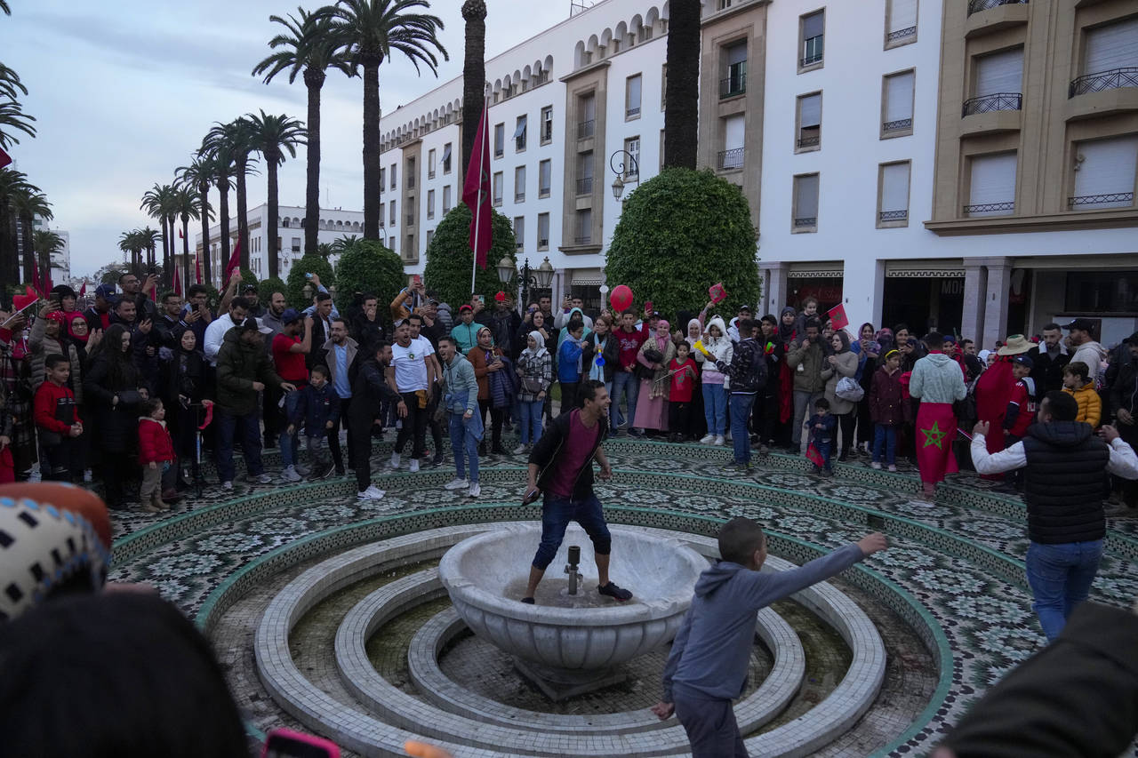 Moroccans celebrate in Rabat, Morocco, Saturday Dec. 10, 2022 their teams victory over Portugal in ...