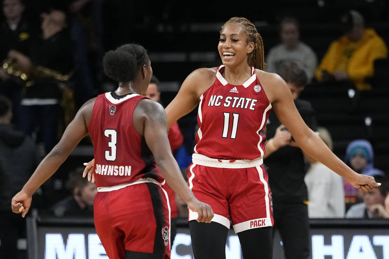 North Carolina State guard Diamond Johnson (3) celebrates with teammate forward Jakia Brown-Turner ...