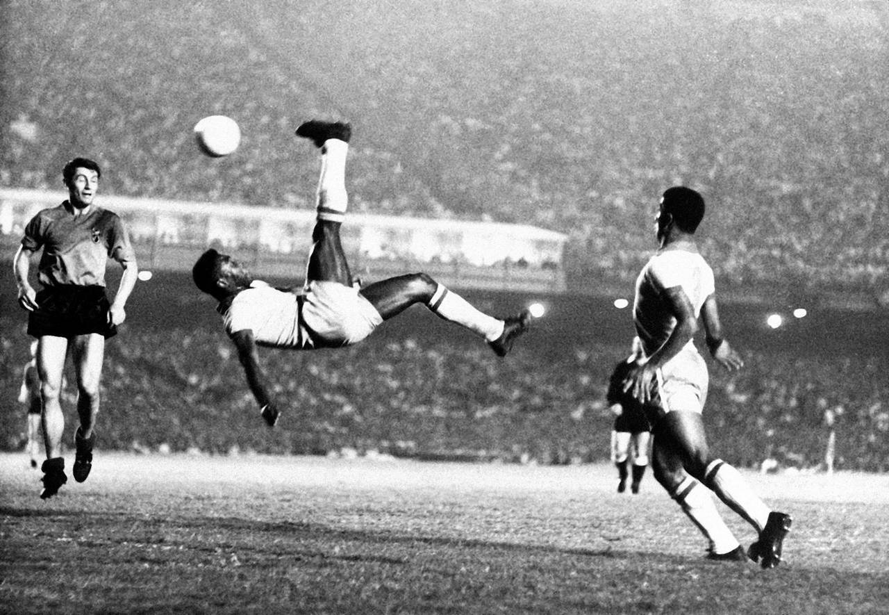 FILE - Brazil's soccer star Pele bicycle kicks a ball during a game at unknown location, Sept. 1968...
