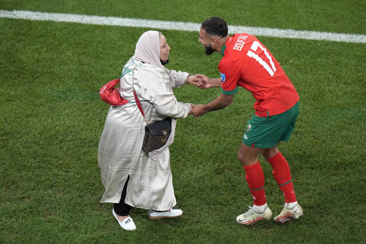 Morocco's Sofiane Boufal, right, celebrates with his mother after his team's win in the World Cup q...