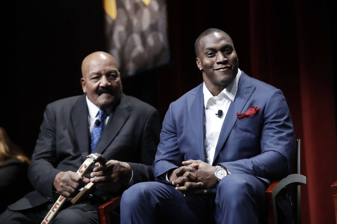 FILE - Former NFL players Jim Brown, left, and Takeo Spikes are shown during a sports and activism ...