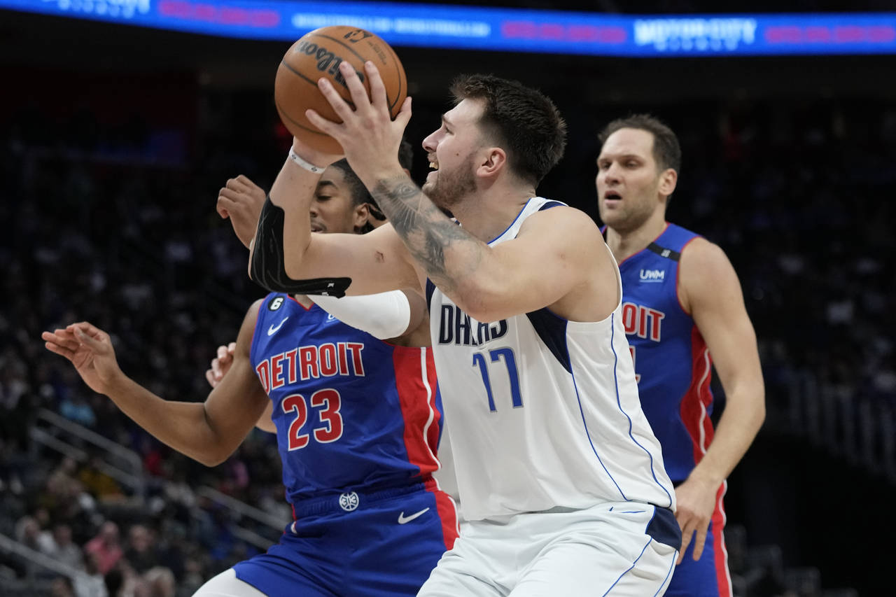 Dallas Mavericks guard Luka Doncic (77) is defended b Detroit Pistons guard Jaden Ivey (23) during ...