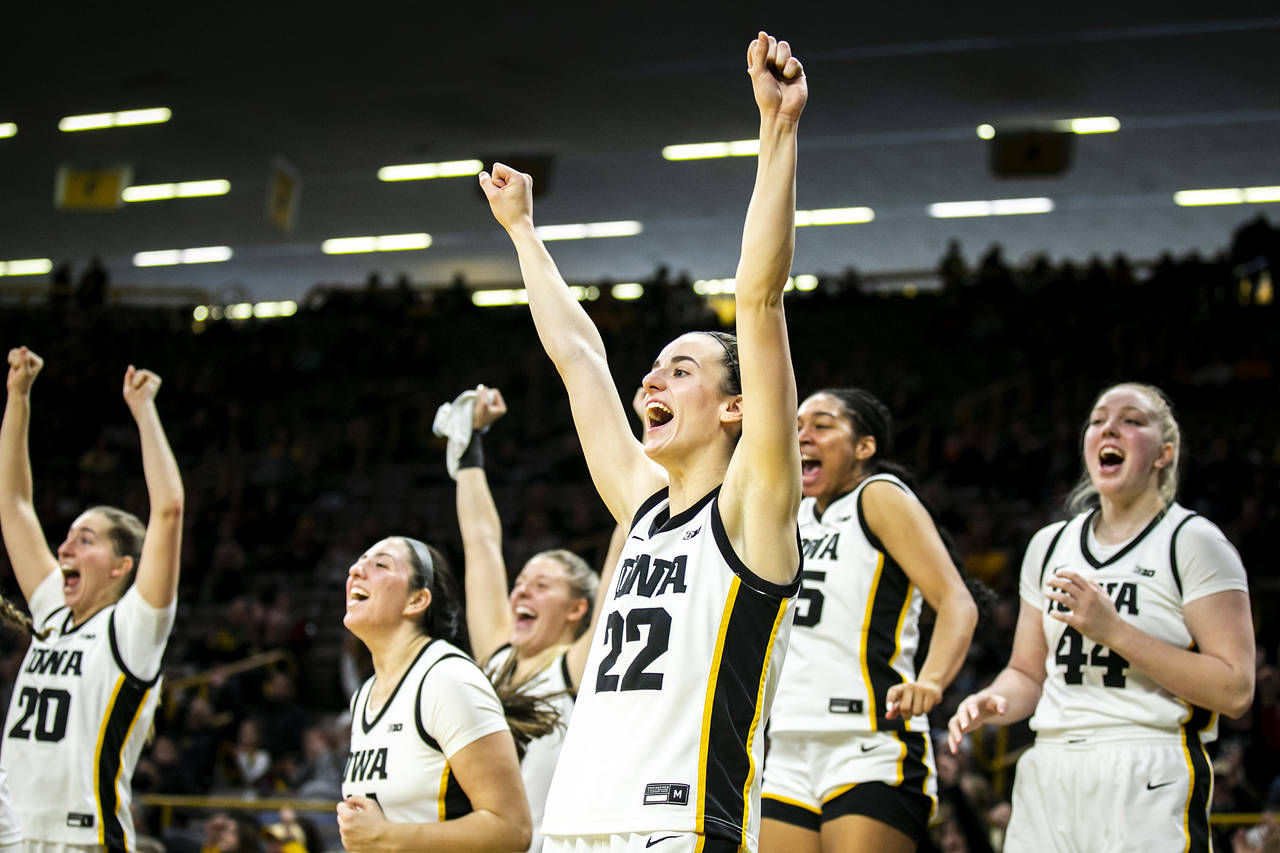 Iowa guard Caitlin Clark (22) cheers on teammates during an NCAA college basketball game against Da...