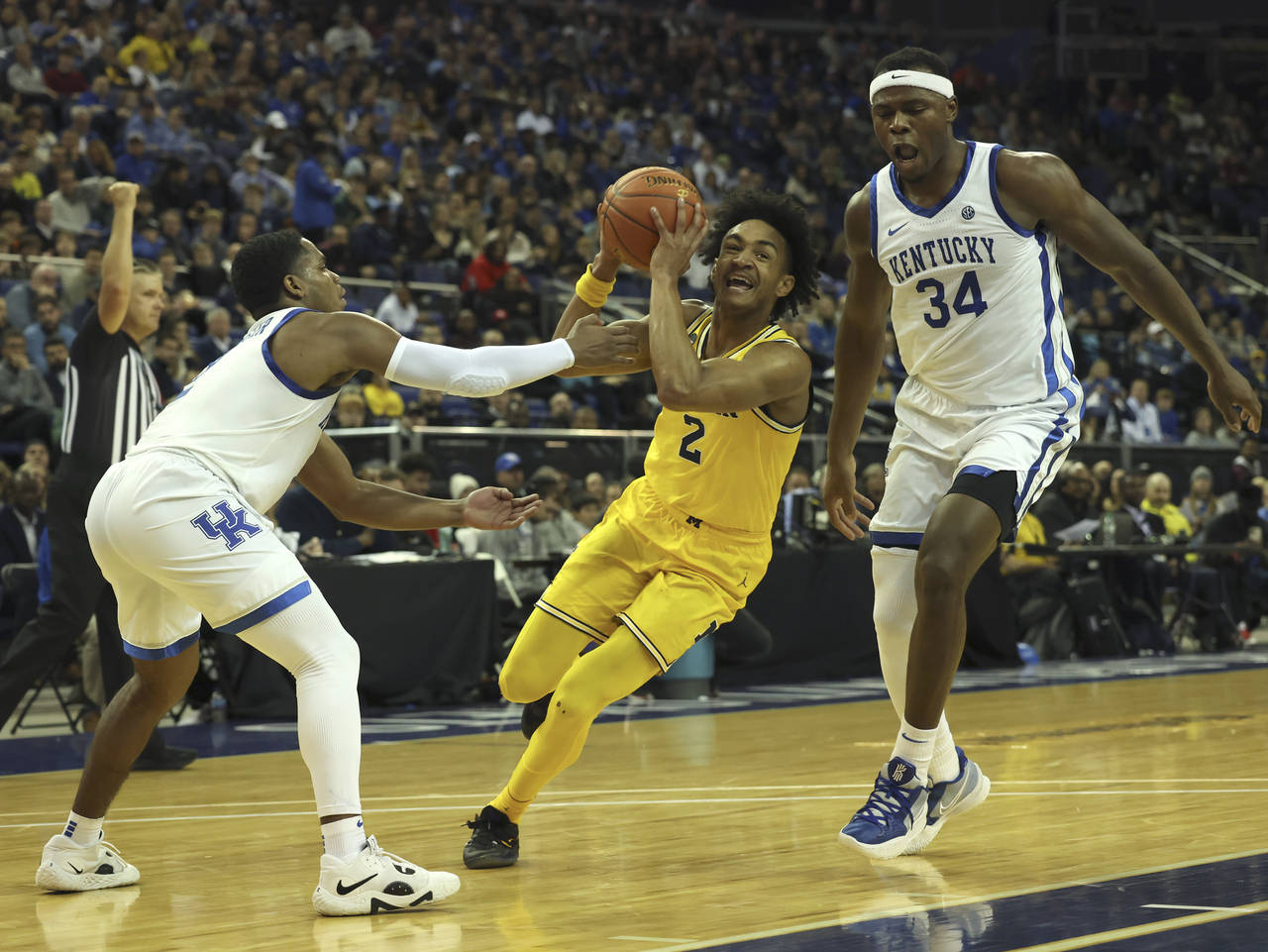 Michigan Wolverines' Kobe Bufkin (2) goes for the basket as Kentucky Wildcats' Sahvir Wheeler (2), ...