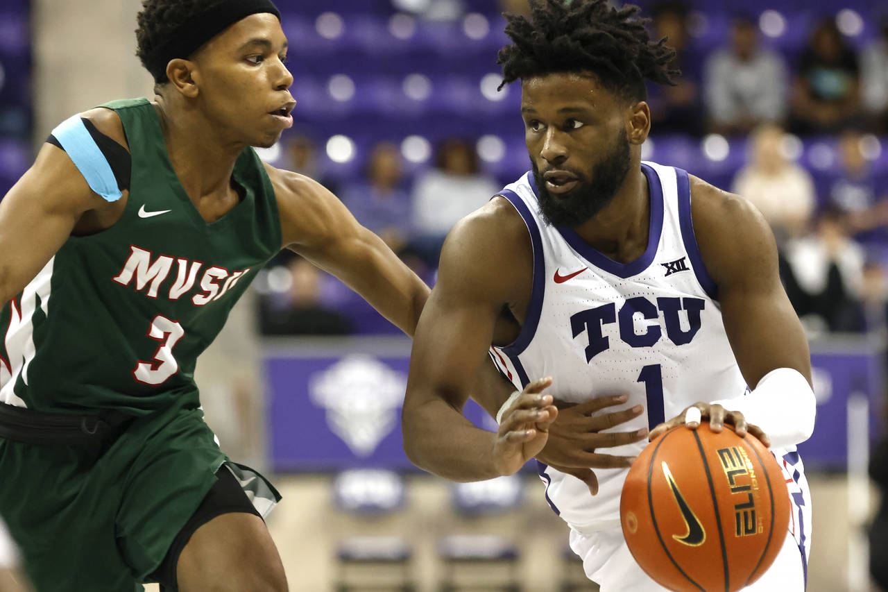 TCU guard Mike Miles Jr. (1) handles the ball as Mississippi Valley State guard Kadar Waller (3) de...