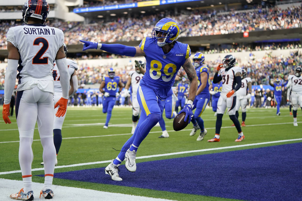 Los Angeles Rams tight end Tyler Higbee celebrates after scoring past Denver Broncos cornerback Pat...