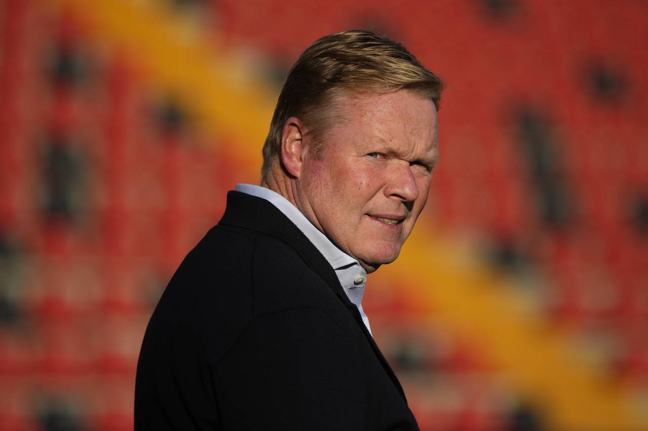 FILE - Barcelona's head coach Ronald Koeman checks the field ahead of the Spanish La Liga soccer ma...