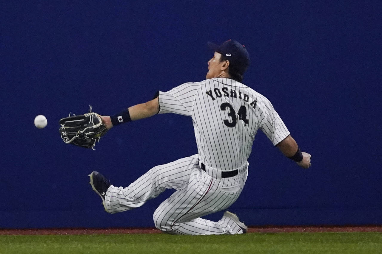 FILE - Japan's Masataka Yoshida cannot reach a ball hit by United States' Triston Casas during the ...