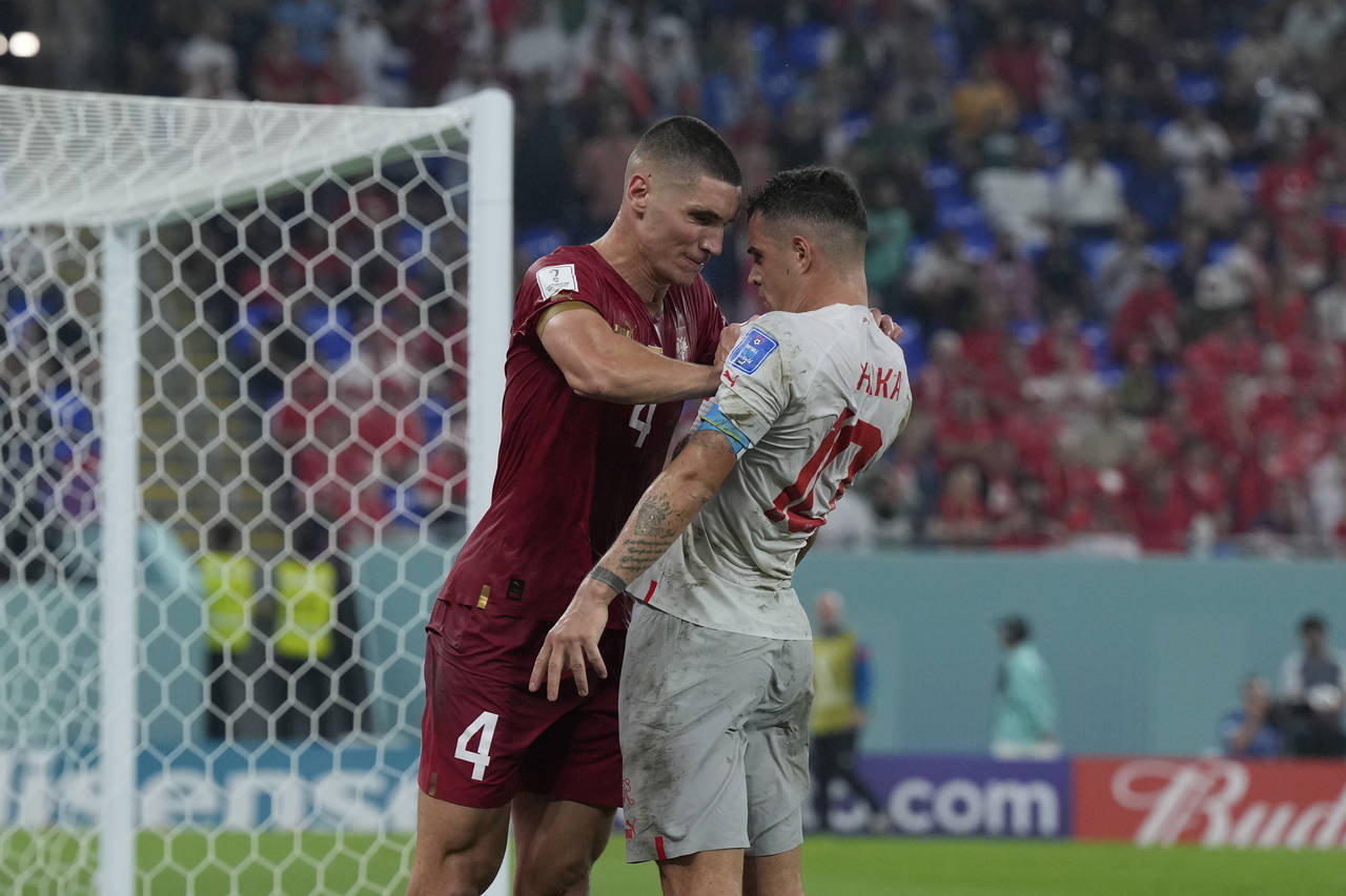 Serbia's Nikola Milenkovic, left, pushes Switzerland's Granit Xhaka during the World Cup group G so...