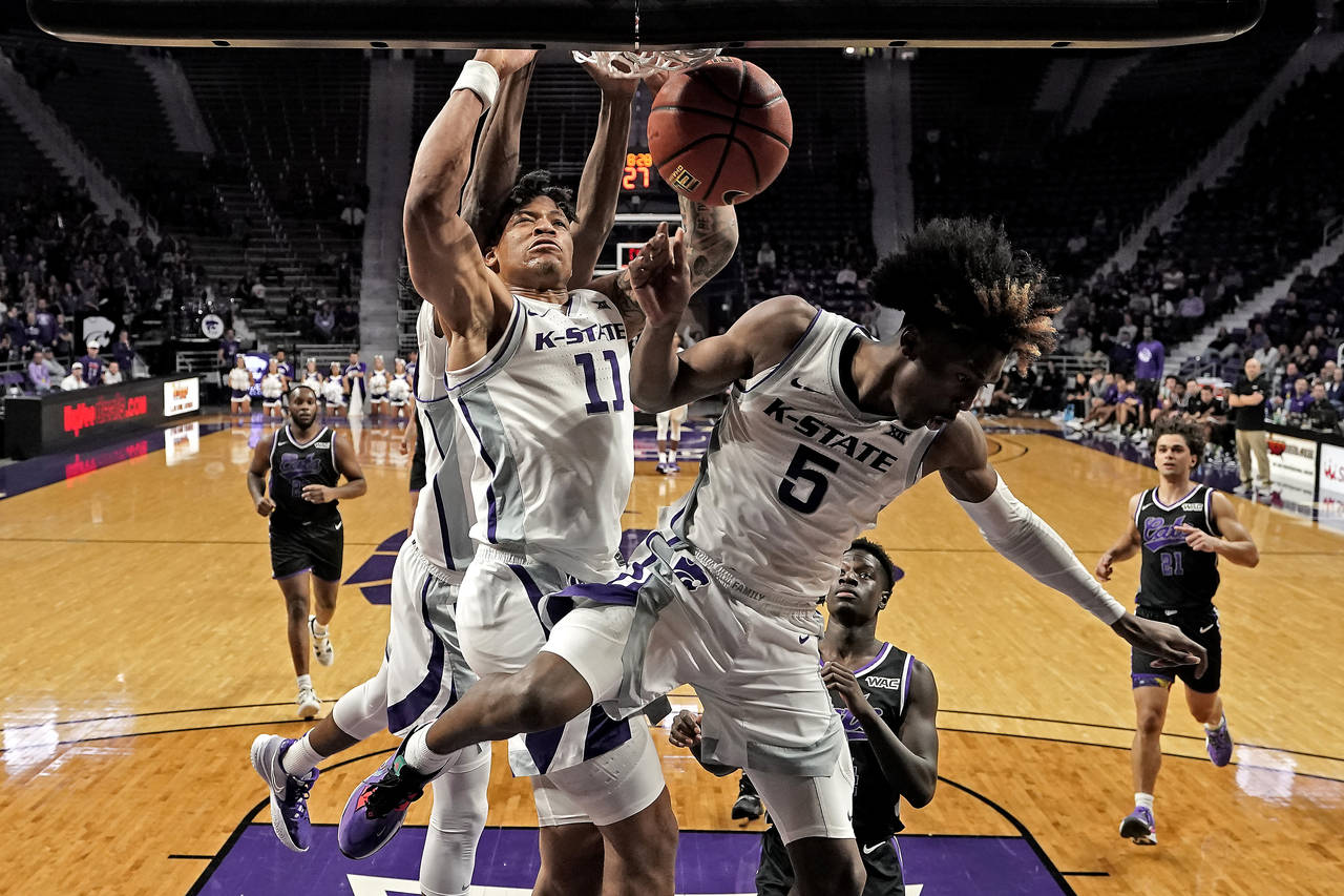 Kansas State forward Keyontae Johnson (11) dunks the ball during the second half of an NCAA college...