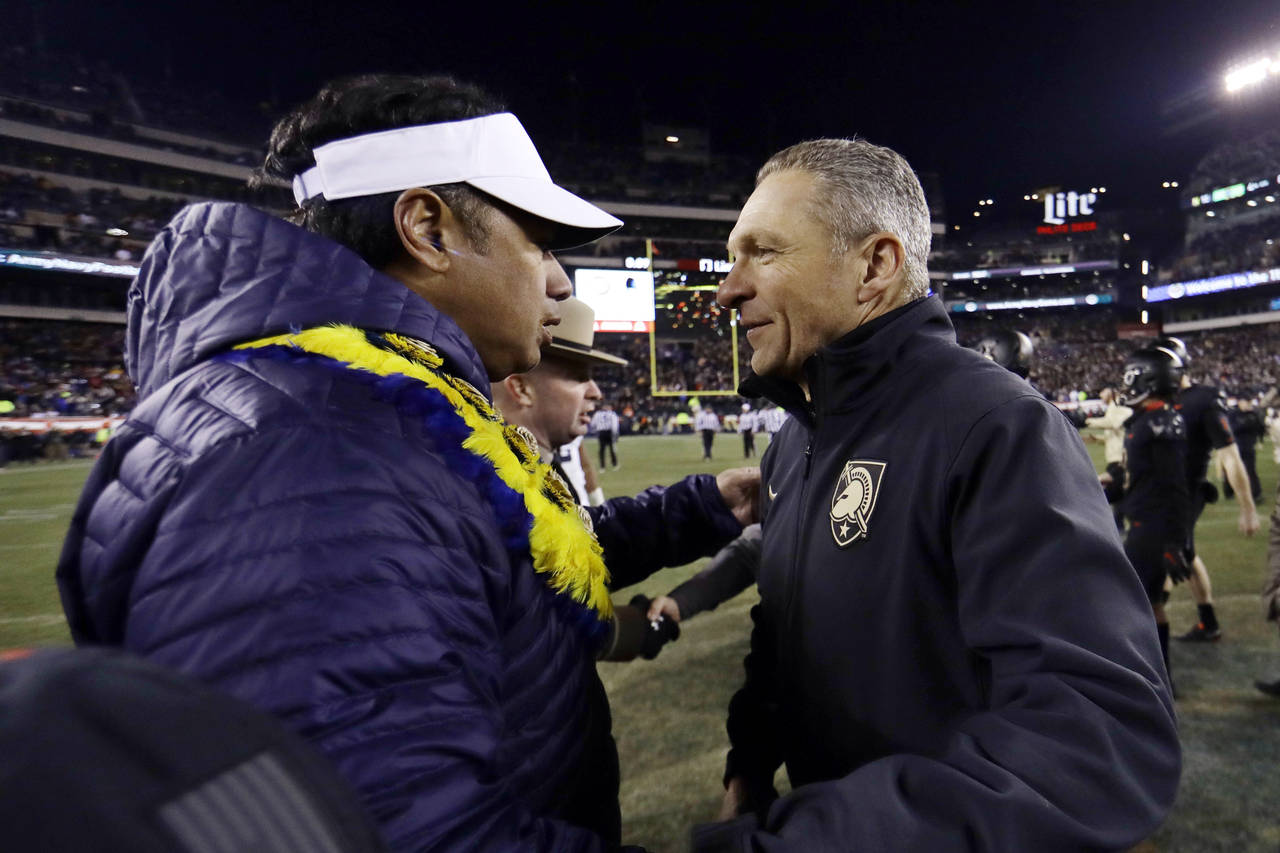 FILE - In this Dec. 8, 2018, file photo, Army head coach Jeff Monken, right, greets Navy head coach...