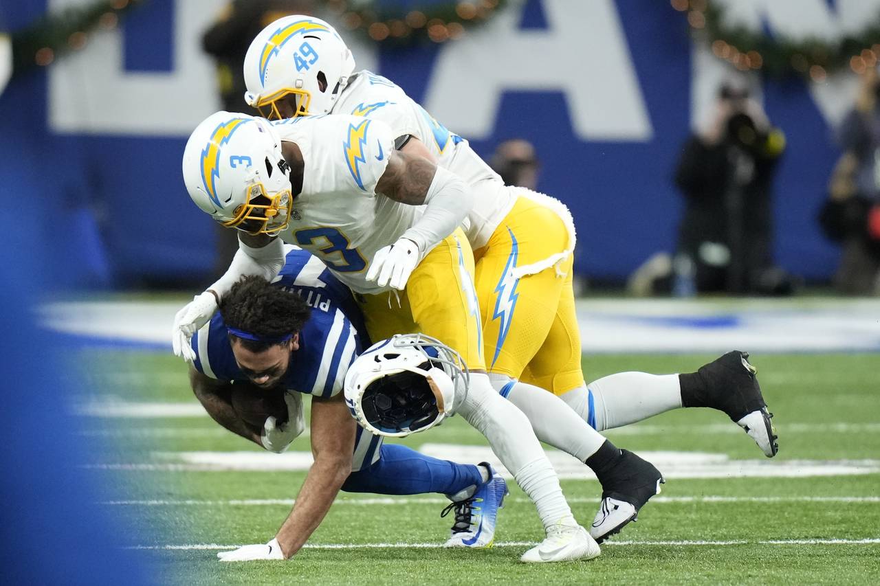 Indianapolis Colts' Michael Pittman Jr. (11) helmet comes off as he is tackled by Los Angeles Charg...