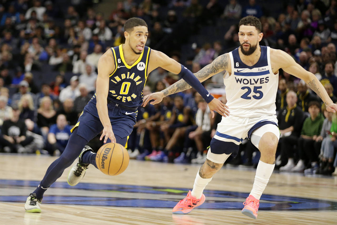 Indiana Pacers guard Tyrese Haliburton (0) drives on Minnesota Timberwolves guard Austin Rivers (25...