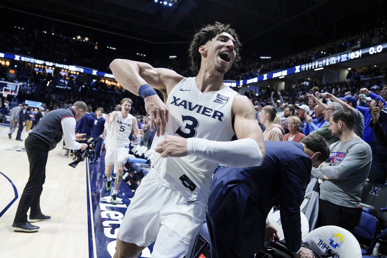 Xavier's Colby Jones (3) reacts after defeating Connecticut in an NCAA college basketball game, Sat...