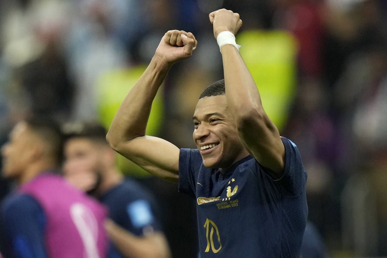 France's Kylian Mbappe celebrates at the end of the World Cup quarterfinal soccer match between Eng...