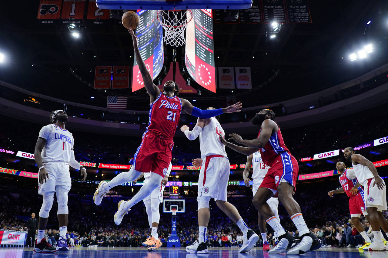 Philadelphia 76ers' Joel Embiid (21) goes up for a shot during the second half of an NBA basketball...