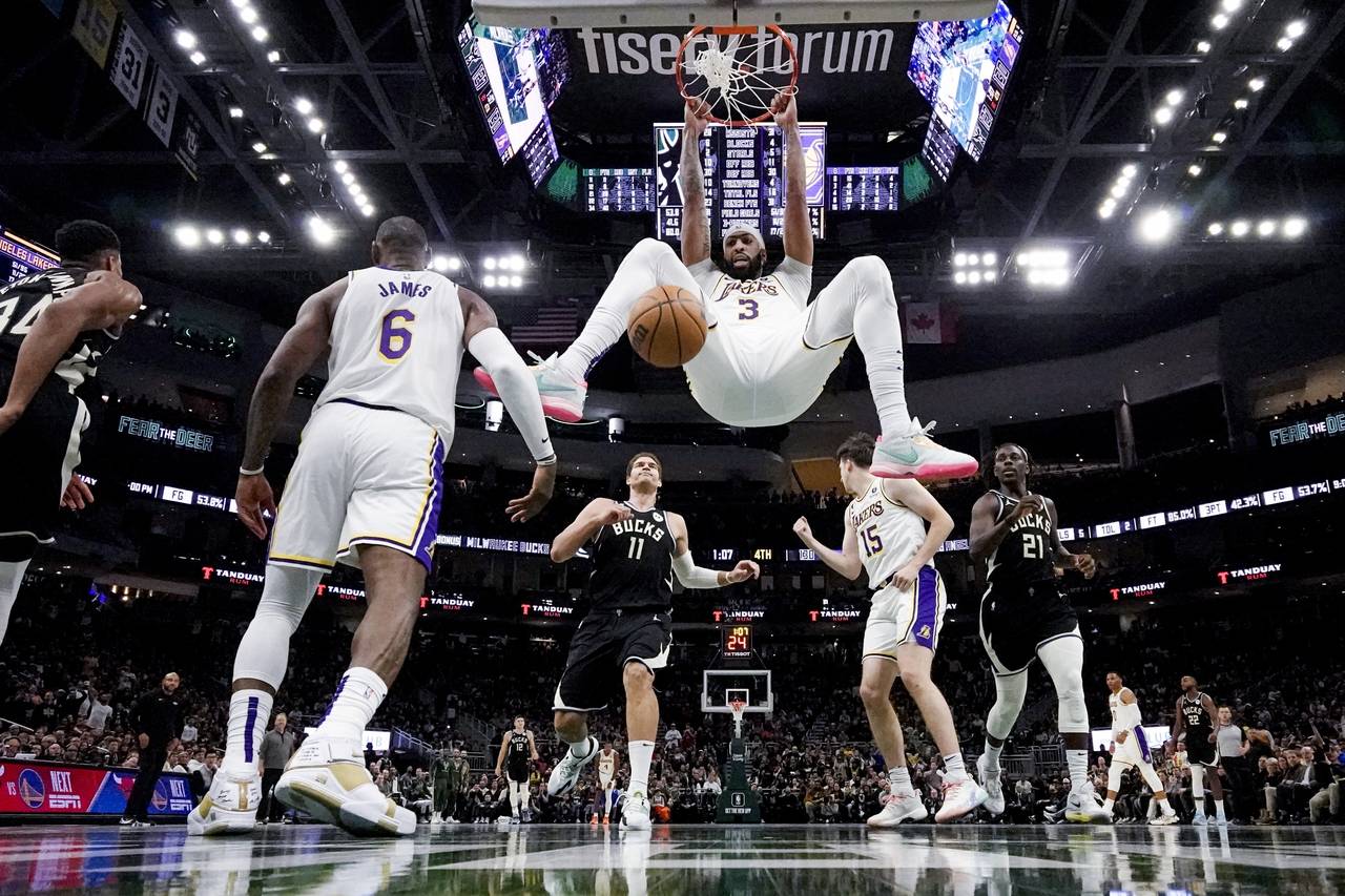 Los Angeles Lakers' Anthony Davis dunks during the second half of an NBA basketball game against th...