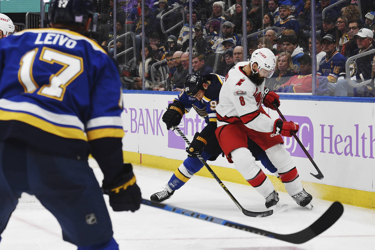 Carolina Hurricanes' Brent Burns (8) vies for the puck against St. Louis Blues' Ryan O'Reilly (90) ...