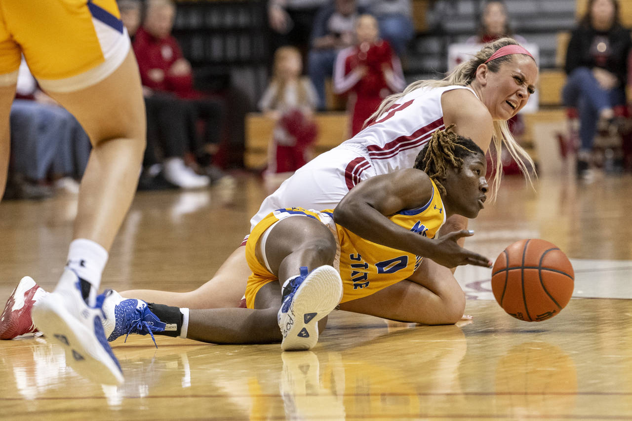 Indiana guard Sydney Parrish, top, reacts as she and Morehead State guard Veronica Charles (0) batt...
