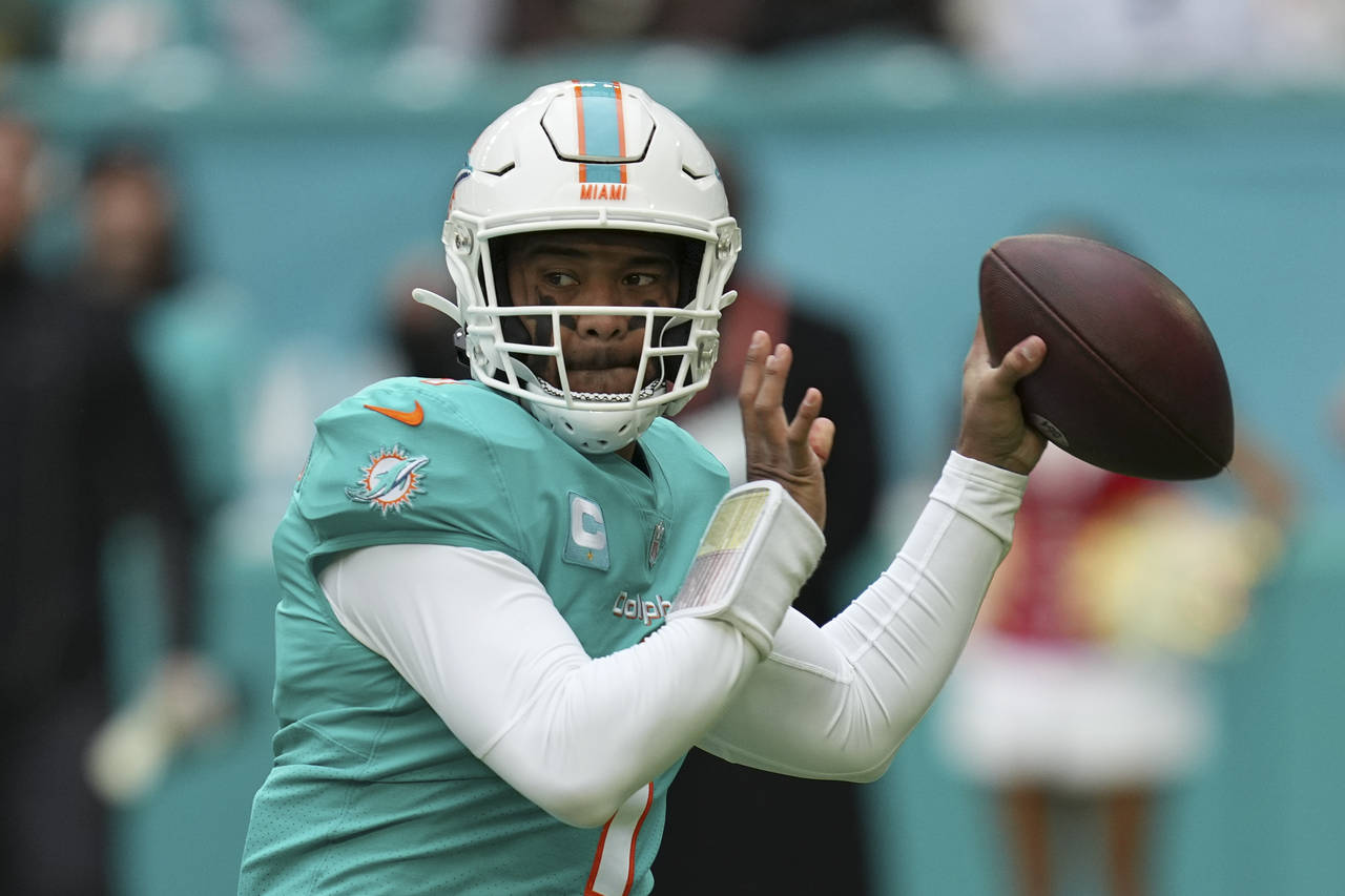 FILE - Miami Dolphins quarterback Tua Tagovailoa (1) looks to pass during the first half of an NFL ...