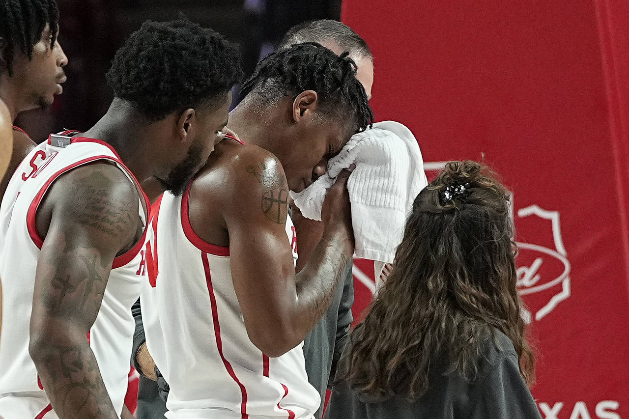Houston guard Marcus Sasser exits the game after sustaining an injury to his face during the first ...